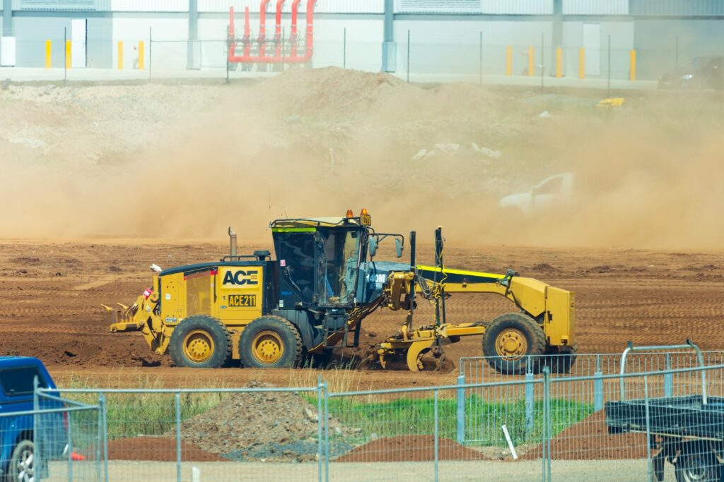 yellow and black heavy equipment on field during daytime