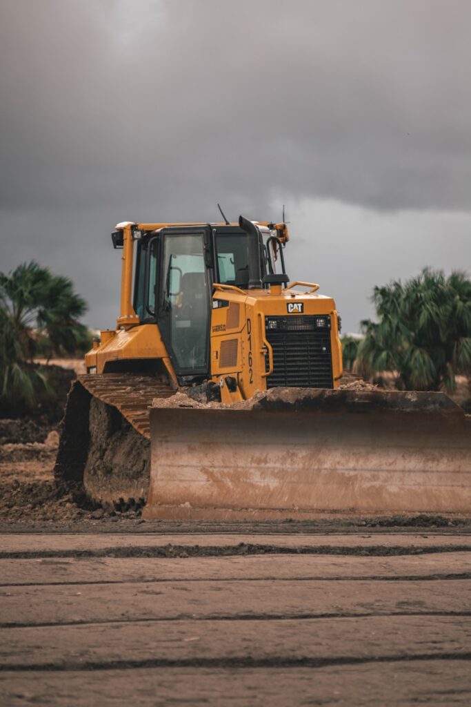 yellow and black heavy equipment on snow covered ground during daytime